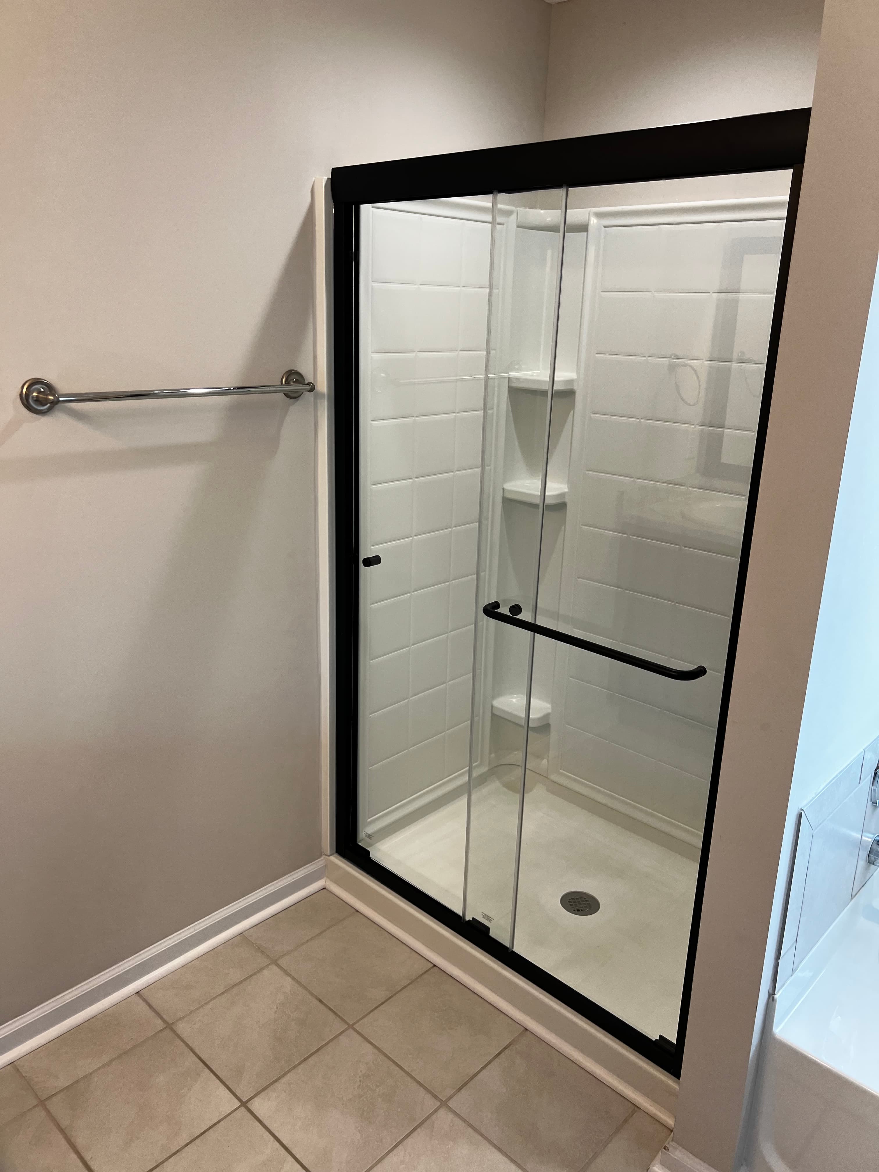 Shower door installation documented for a rental unit