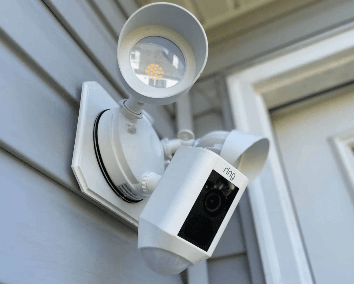 Ring floodlight camera mounted on exterior siding